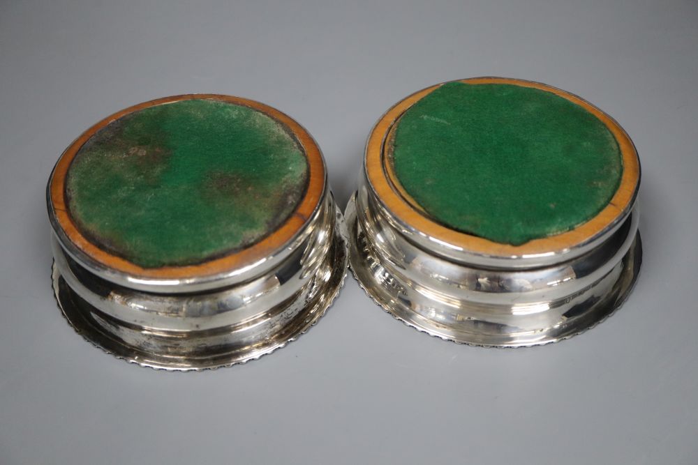 A pair of George IV silver wine coasters with tuned wooden bases, Adey Bellamy Savory, London, 1827, 13.3cm.